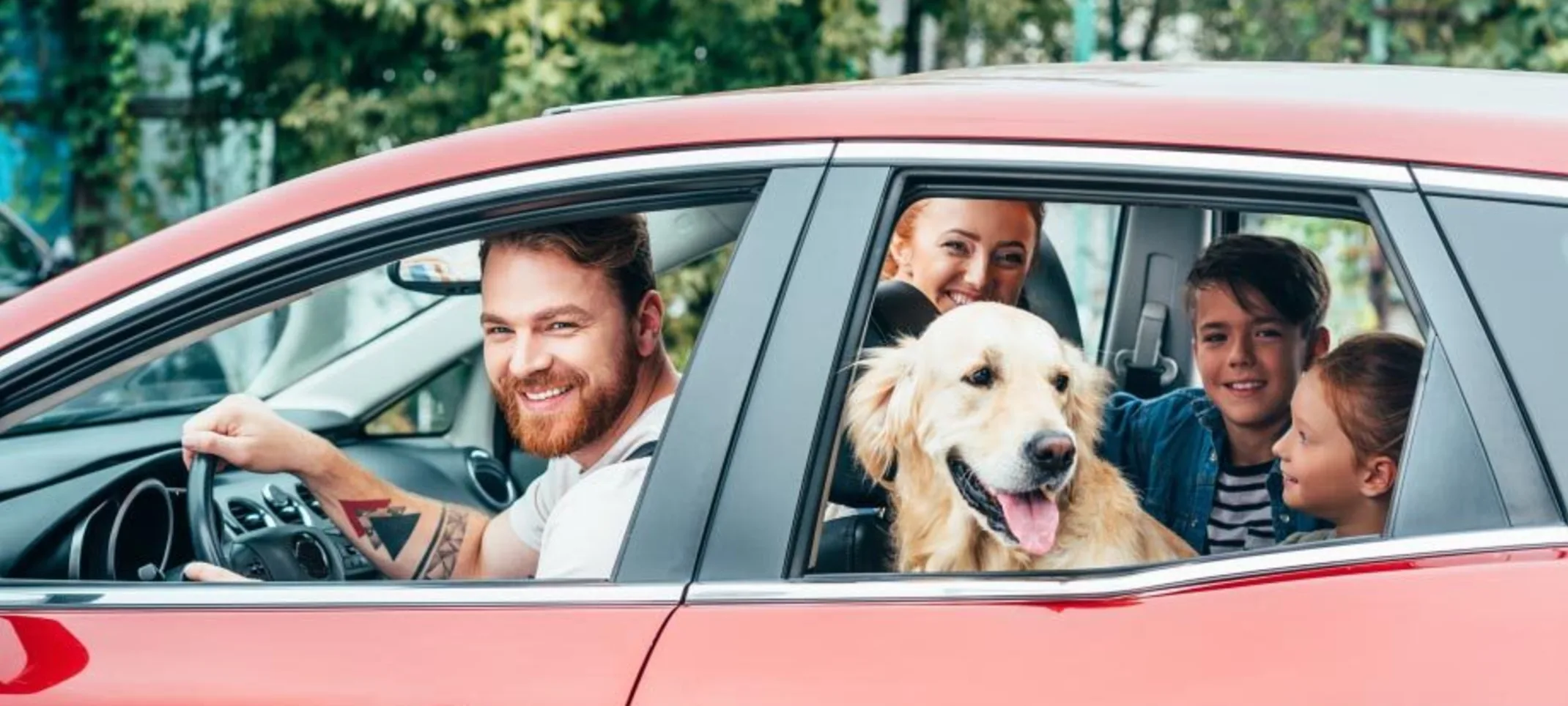 Family in car with a dog